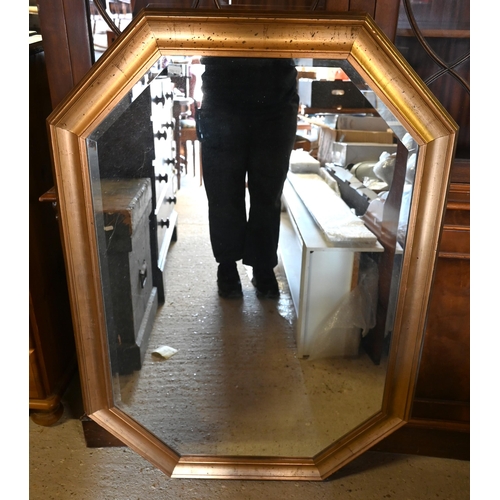 235 - A large bevelled octagonal wall mirror in decorative moulded gilt frame, 97 cm wide x 130 cm high;  ... 