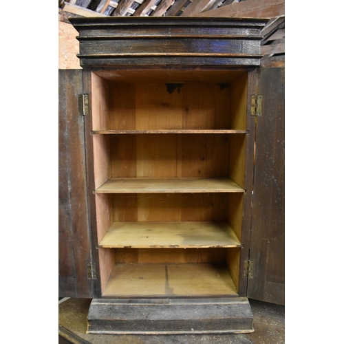 242 - A small antique oak side cabinet with panelled doors enclosing shelves, 48 cm wide x 26 cm deep x 83... 