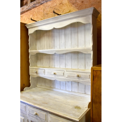 243 - A pine dresser with white distress painted finish, 122 cm wide x 60 cm deep x 198 cm high