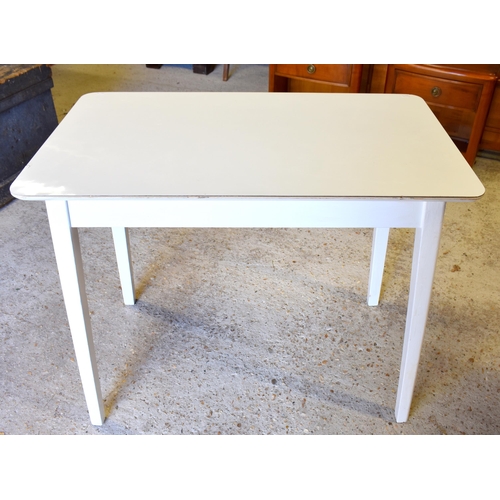 292 - A white painted side table wtih melamine top to/w two Ercol style spindle-back chairs (one standard ... 