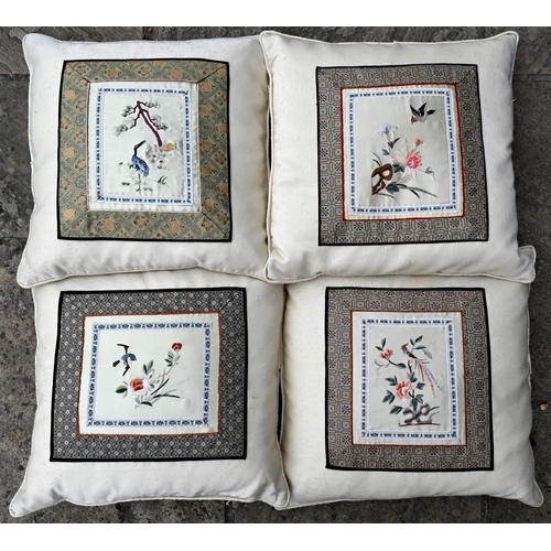 373 - A set of four cream silk slub cushions with applied Chinese embroidered panels, to/w a pair of frame... 