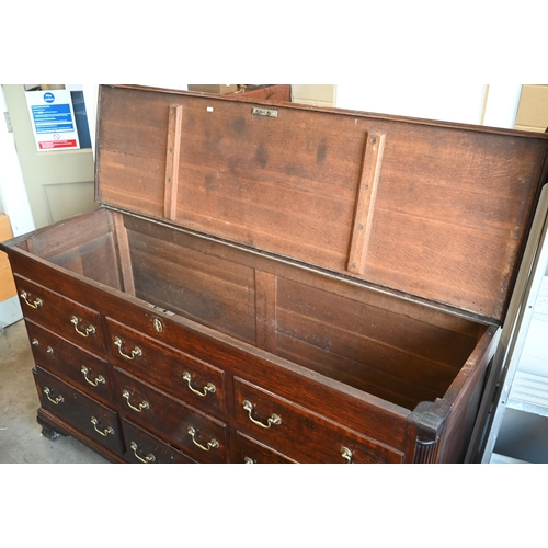 390 - A large Georgian oak mule chest with an arrangement of three rows of three dummy drawers with brass ... 