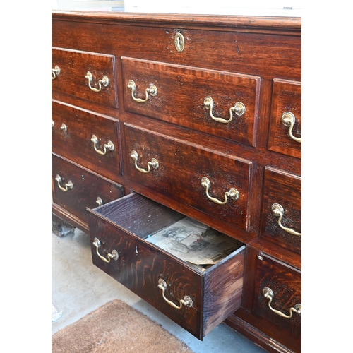 390 - A large Georgian oak mule chest with an arrangement of three rows of three dummy drawers with brass ... 