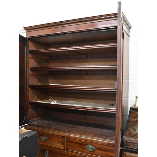 392 - A 19th century mahogany linen press with panelled doors enclosing four slides over two short and two... 