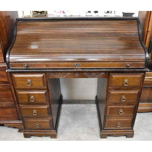 393 - An early 20th century oak roll top desk with sliding tambour panel enclosing fitted interior (locked... 