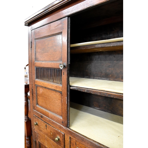 404 - An 18th century Welsh oak pantry cupboard with panelled doors and two drawers, 115 cm w x 50 cm d x ... 