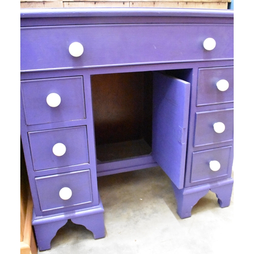 415 - A small blue painted kneehole desk with central cupboard and seven drawers