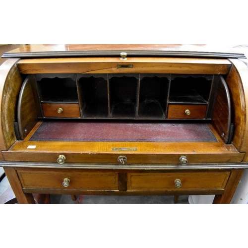 418 - A 19th century mahogany inlaid cylinder top desk with fitted interior and two drawers raised on tape... 