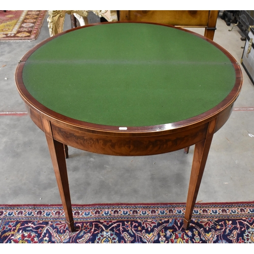 434 - A 19th century mahogany inlaid demi lune card table with folding base and lined top on tapering squa... 