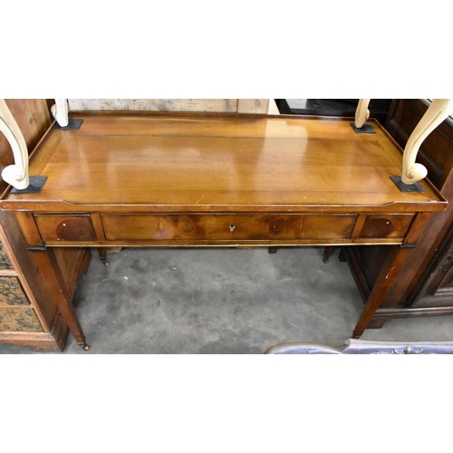 435 - An Empire style fruit wood three drawer writing table on tapering square supports with brass casters... 