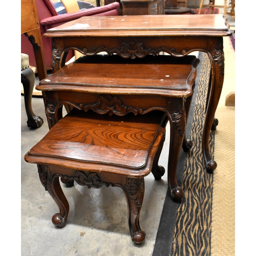 440 - Nest of three hardwood tables with foliate carved decoration