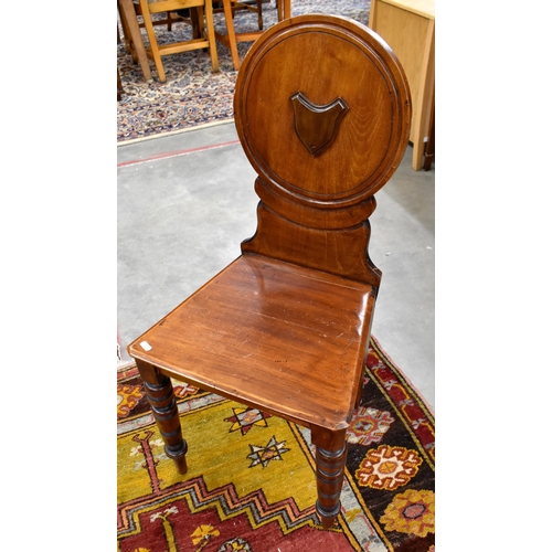 448 - A 19th century mahogany circular backed hall chair, provincial elm wheelback carver chair and oak si... 