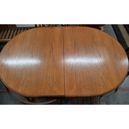 453 - A mid century G-Plan Fresco teak extending dining table, the sliding top opening to allow the storab... 