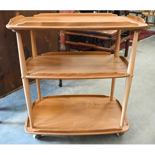 460 - An Ercol (model 458) Golden Dawn light elm and beech three-tier tea trolley on ball castors circa 19... 