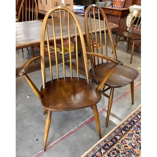 465 - An Ercol dark elm refectory style dining table with shaped supports and pegged stretcher, 182 cm x 8... 