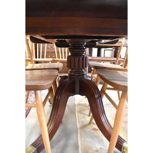 472 - A Victorian mahogany tilt top dining table with brass casters, 121 x 93 x 71 cm