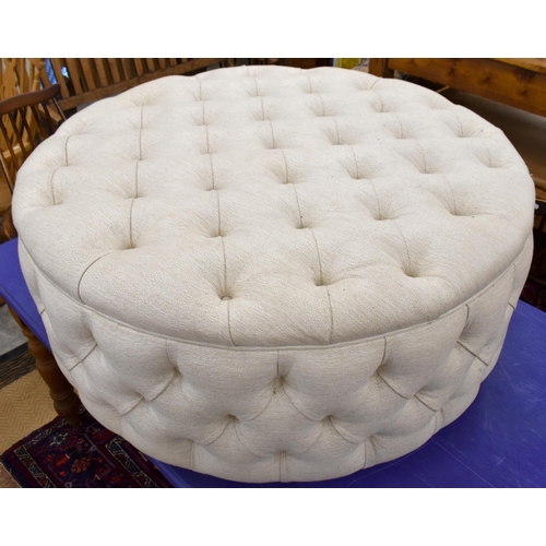 478 - A large circular button upholstered centre stool, ivory fabric upholstery on stained hardwood plinth... 