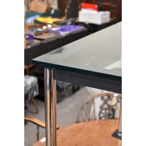 486 - A contemporary Italian Cassina 'Le Courbusier' dining table with tinted glass top and tubular chrome... 