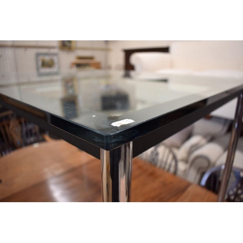 486 - A contemporary Italian Cassina 'Le Courbusier' dining table with tinted glass top and tubular chrome... 