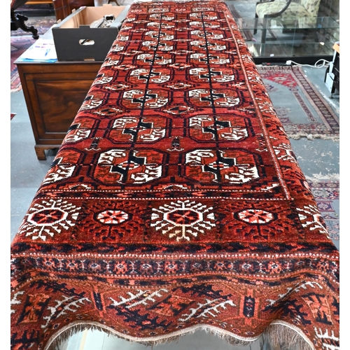 502 - An old Turkman Tekke rug, the red-brown ground with geometric guls, 218 x 120 cm