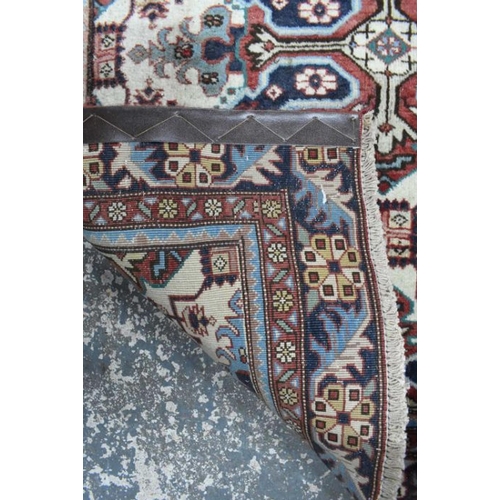 503 - A Persian Heriz runner, the linked geometric floral design on camel ground, 286 cm x 106 cm