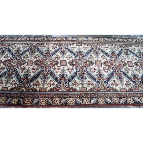 503 - A Persian Heriz runner, the linked geometric floral design on camel ground, 286 cm x 106 cm