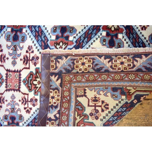 503 - A Persian Heriz runner, the linked geometric floral design on camel ground, 286 cm x 106 cm