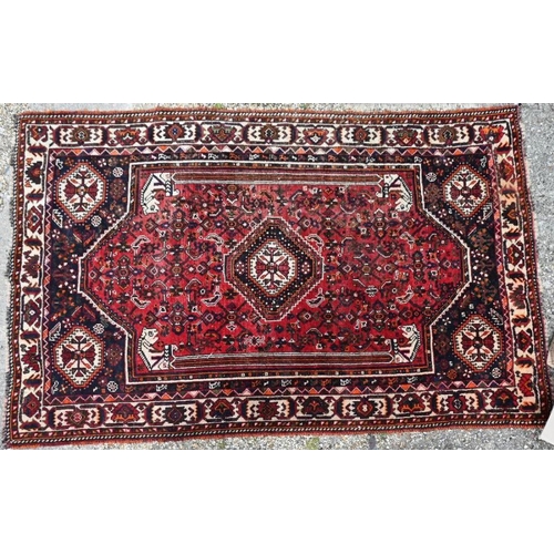 505 - An old Persian Shiraz carpet, the traditional red ground centred by a diamond lozenge, 268 x 166 cm