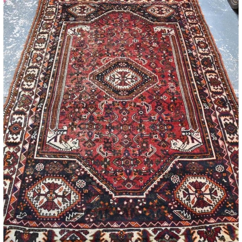 505 - An old Persian Shiraz carpet, the traditional red ground centred by a diamond lozenge, 268 x 166 cm