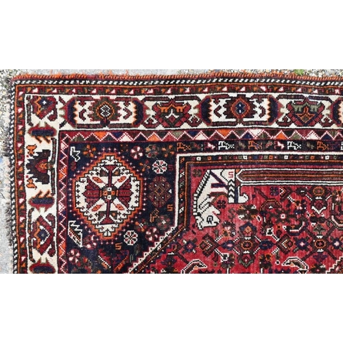 505 - An old Persian Shiraz carpet, the traditional red ground centred by a diamond lozenge, 268 x 166 cm