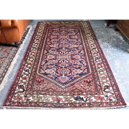 506 - A Malayer carpet, the stylised floral design on dark blue ground, 290 x 150 cm