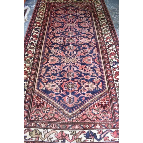 506 - A Malayer carpet, the stylised floral design on dark blue ground, 290 x 150 cm