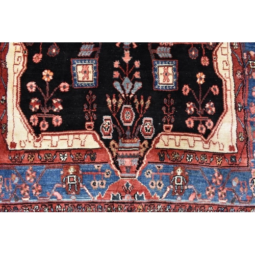 507 - A Persian Nahawand carpet, centred by a large ink black medallion within multi-coloured borders, 245... 