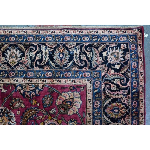 509 - A Persian Meshed carpet, the wine ground with geometric floral design incorporating the weavers sign... 