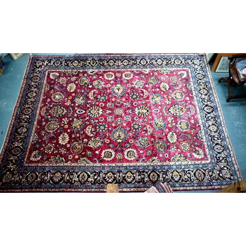 509 - A Persian Meshed carpet, the wine ground with geometric floral design incorporating the weavers sign... 