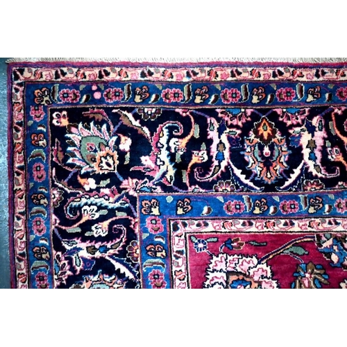 509 - A Persian Meshed carpet, the wine ground with geometric floral design incorporating the weavers sign... 