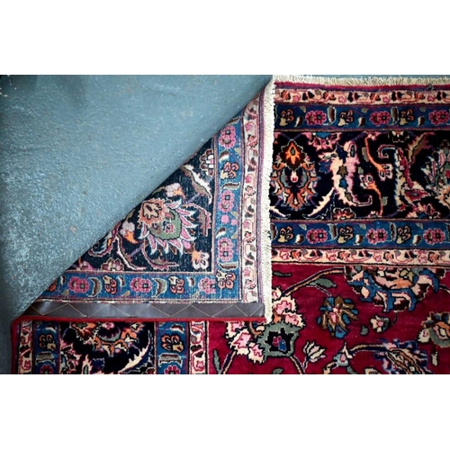 509 - A Persian Meshed carpet, the wine ground with geometric floral design incorporating the weavers sign... 