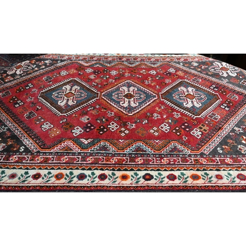 515 - A contemporary Persian Qashqai rug, the blue-brown ground with stylised floral design, 210 cm x 135 ... 