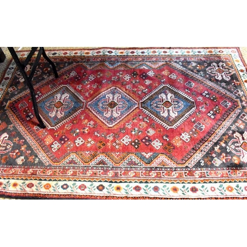 515 - A contemporary Persian Qashqai rug, the blue-brown ground with stylised floral design, 210 cm x 135 ... 