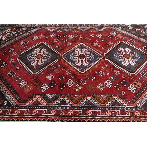 515 - A contemporary Persian Qashqai rug, the blue-brown ground with stylised floral design, 210 cm x 135 ... 