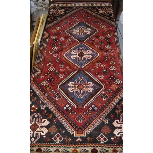 515 - A contemporary Persian Qashqai rug, the blue-brown ground with stylised floral design, 210 cm x 135 ... 