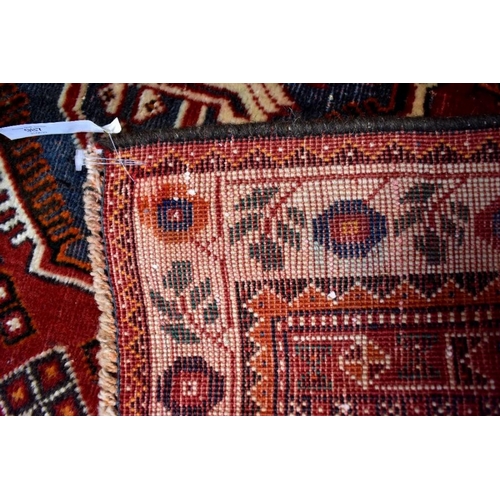 515 - A contemporary Persian Qashqai rug, the blue-brown ground with stylised floral design, 210 cm x 135 ... 