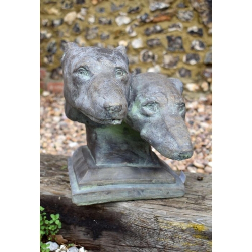 54 - A reconstituted stone garden ornament of two greyhound heads on plinth base, aged bronzed finish, 30... 