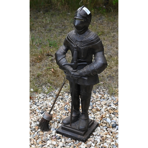 559 - A cast metal poker stand/doorstop, modelled as a suit of armour, 67 cm