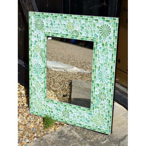 560 - A Gothic arch shaped wall mirror with cream painted frame and polychrome floral sprays, 111 x 61 cm,... 