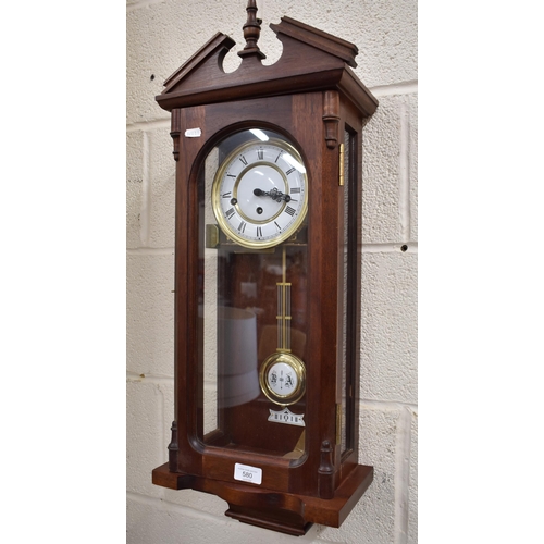 580 - A reproduction German Vienna style wall clock with glazed teak case, triple train movement striking ... 