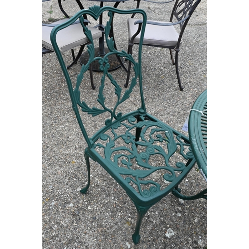 60 - A Victorian style weathered green painted terrace table and two elbow chairs (3)