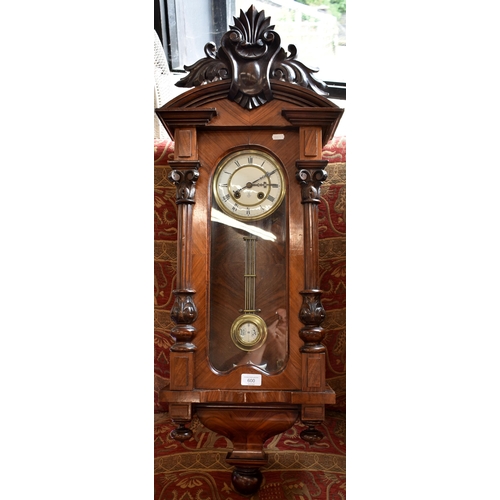 600 - Gustav Becker - a walnut cased German Vienna wall clock with foliate carved glazed case, enamelled b... 