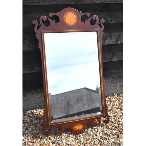 609 - A Georgian style wall mirror with rectangular bevelled plate in fret-cut walnut frame with shell inl... 