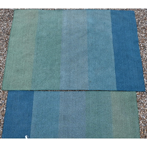 611 - A contemporary wool rug with hues of blues banded design, 230 cm x 156 cm, to/w a matching hall runn... 